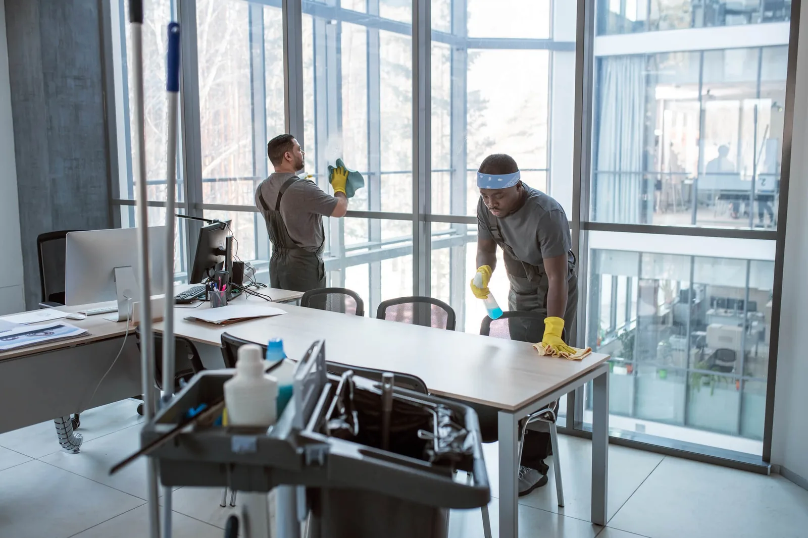 Cleaning crew vacuuming and mopping an open plan office