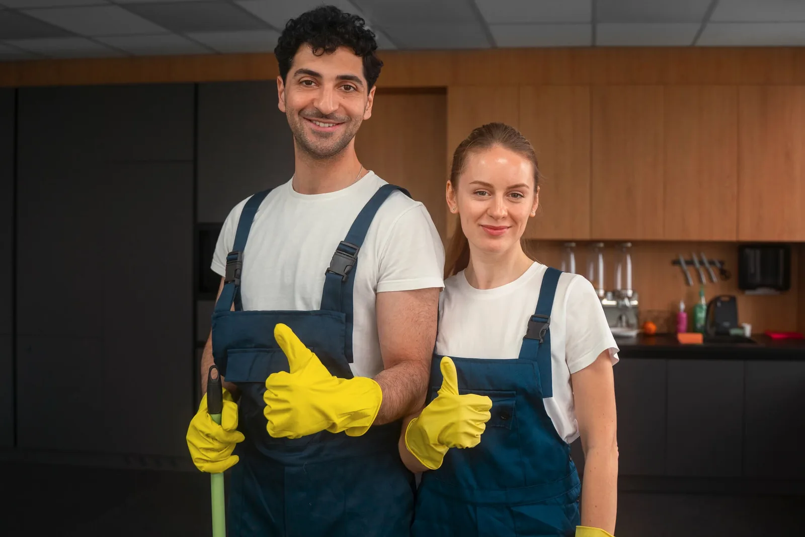 Cleaner wiping a white desk in an office