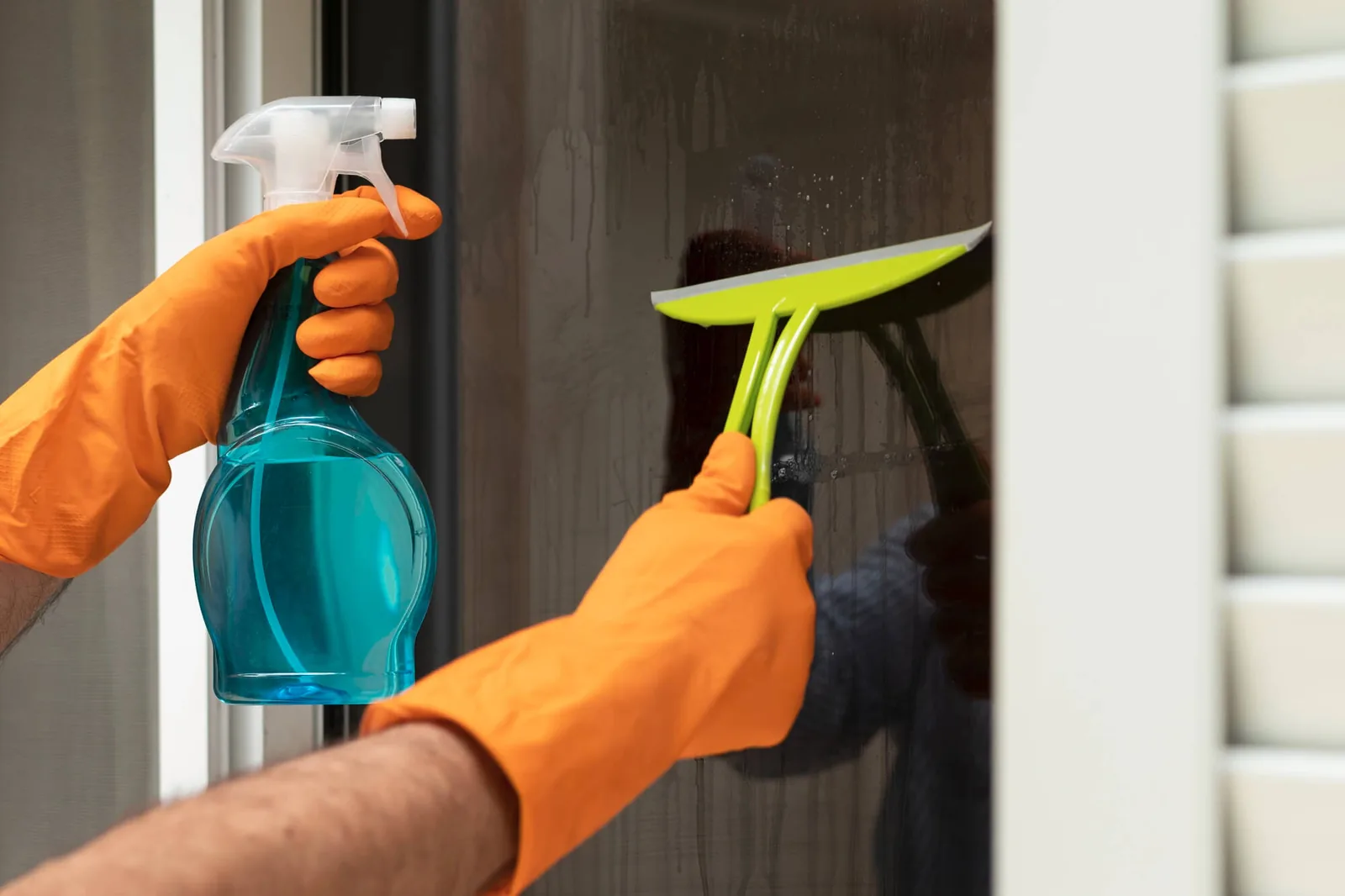 Two cleaners wiping glass and desks in a new office fit out